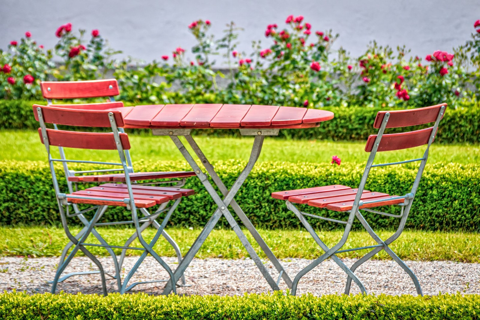 Garden furniture set with rattan sofa, armchairs and coffee table on a planted terrace