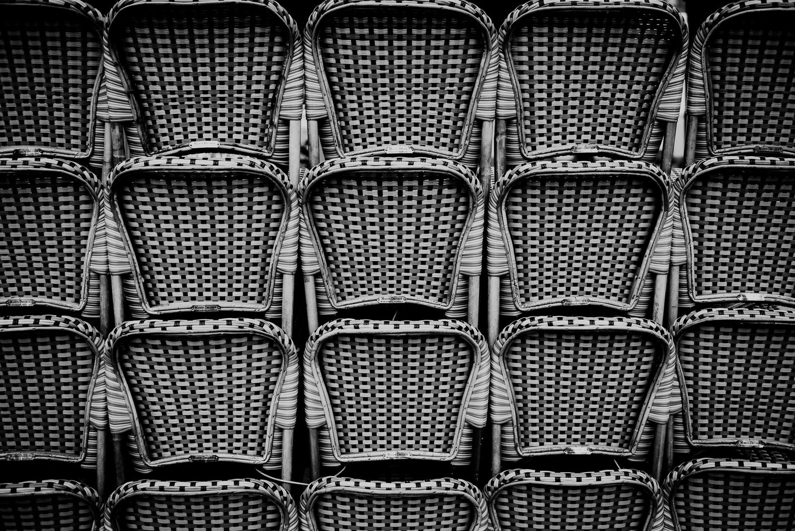 Stacked woven garden chairs ready for packing and container loading