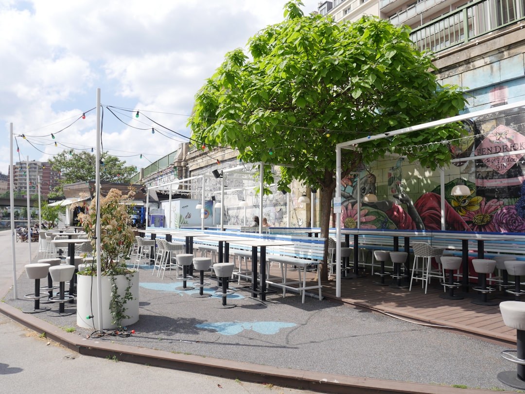 Outdoor cafe patio with a bar counter and commercial tables and chairs set for evening service