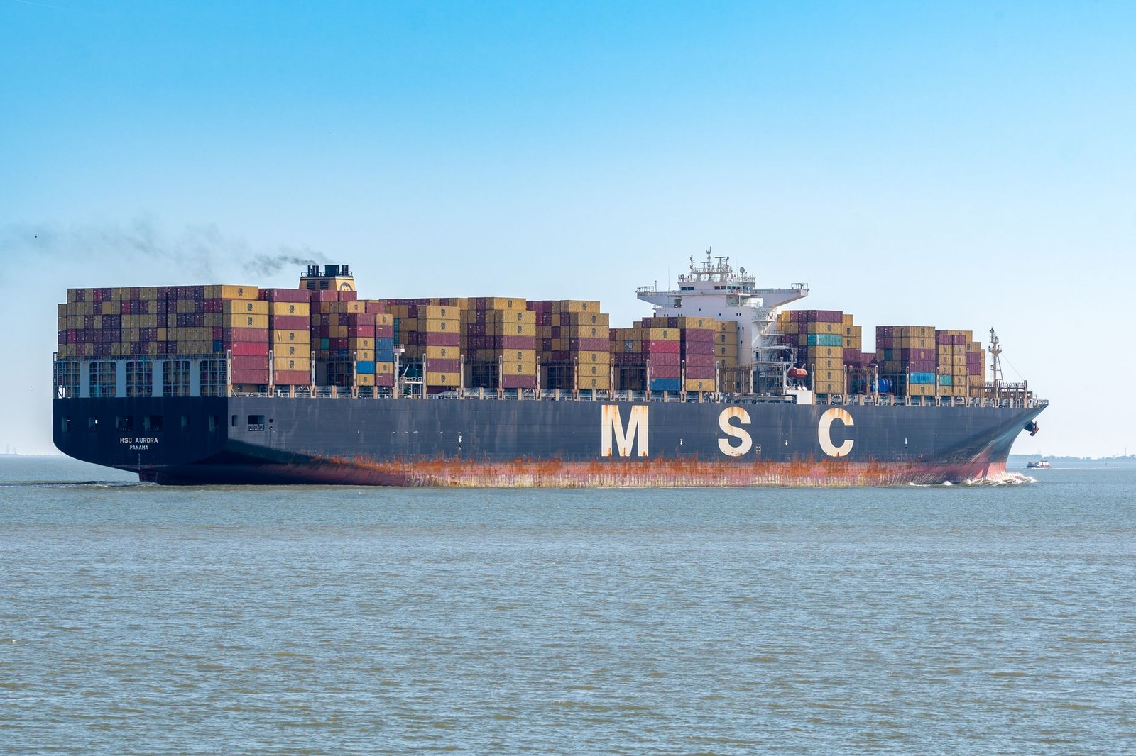 Container ship carrying export cargo on the ocean