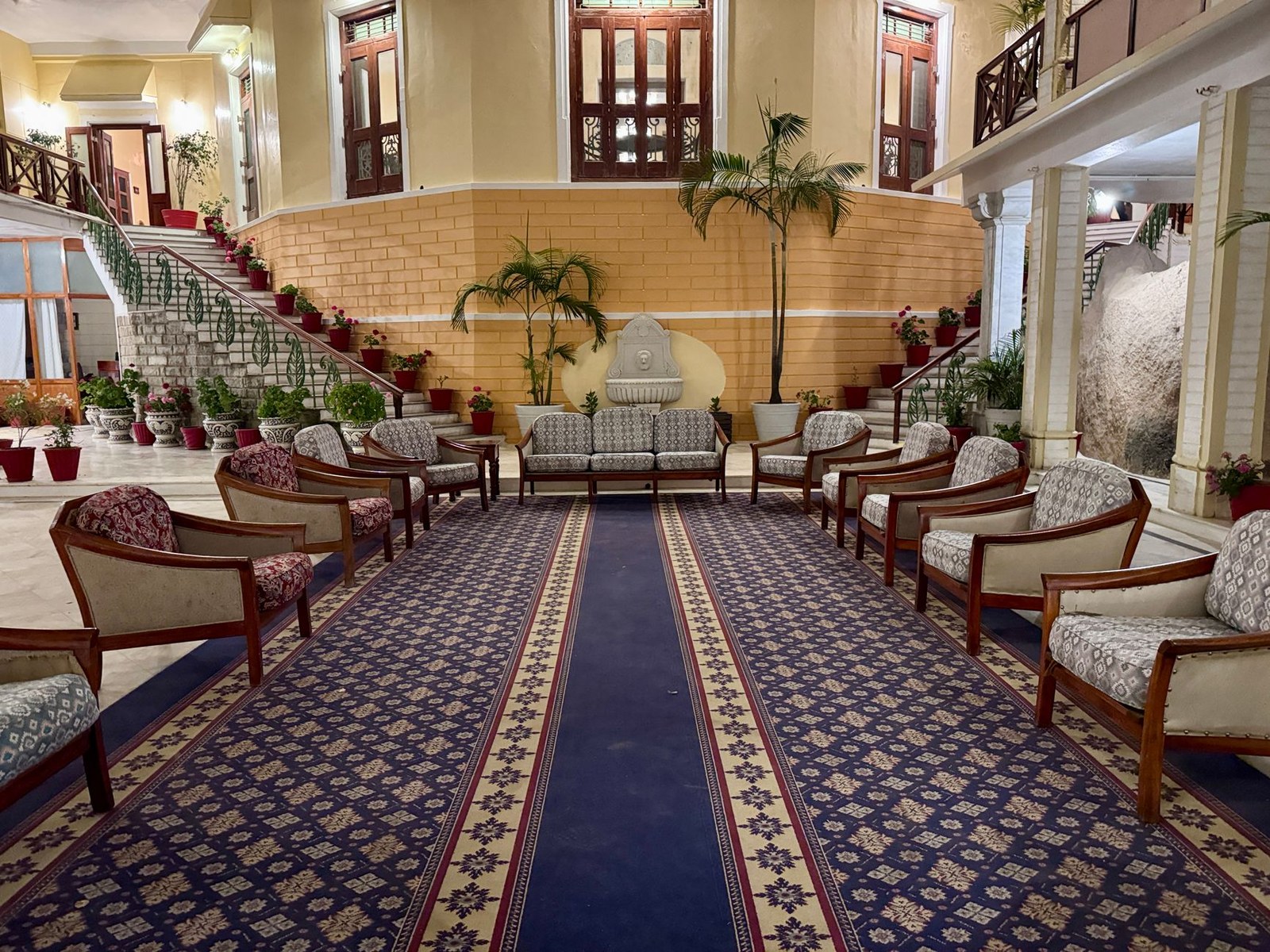 Decorated hotel lobby interior with upholstered lounge seating and side tables