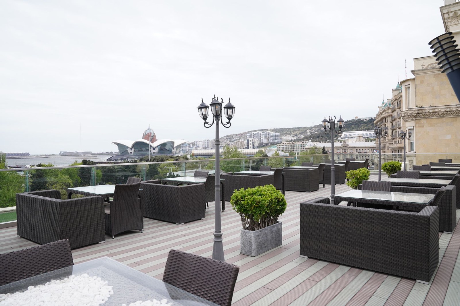 Spacious outdoor hotel terrace laid out with lounge furniture and planters