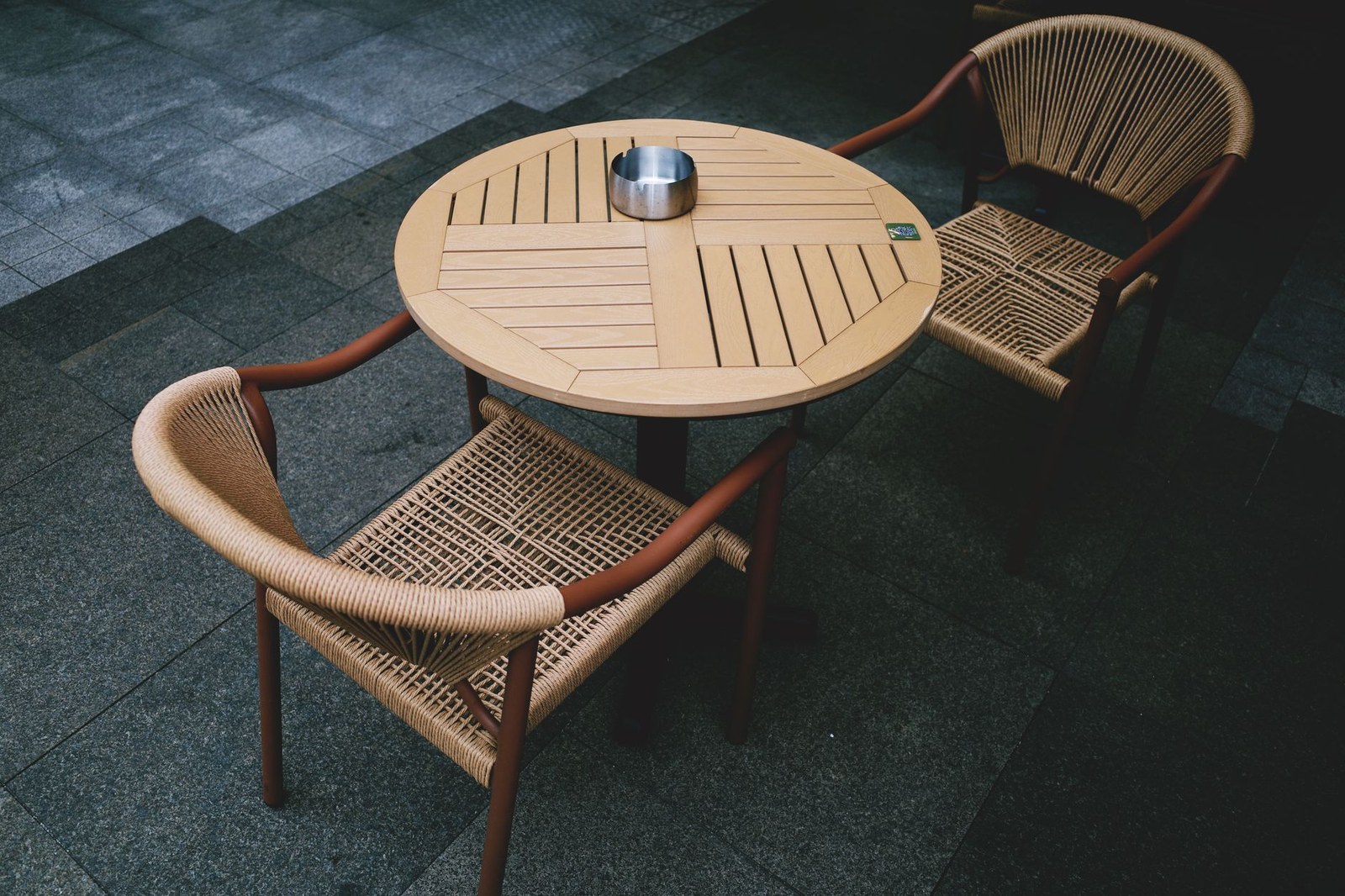 Wicker garden dining set on an intimate UK terrace for a commercial hospitality project