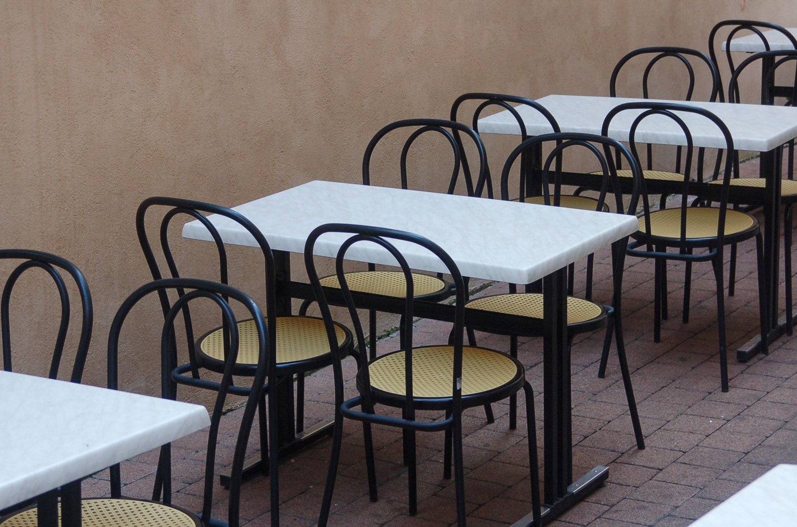 Neatly arranged outdoor cafe terrace with commercial tables and chairs for a US hospitality project