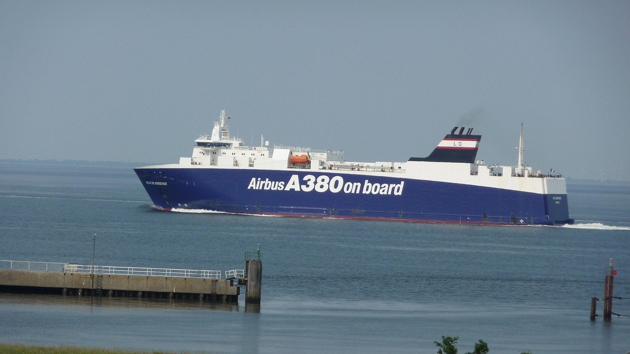 Container ship carrying export cargo leaving port, illustrating outdoor furniture imports from China
