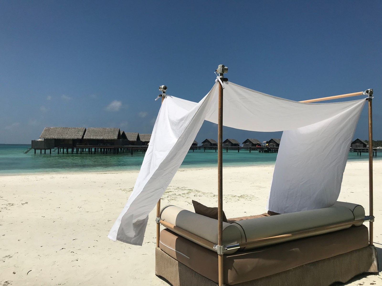Beachside cabana with canopy seating at a coastal resort