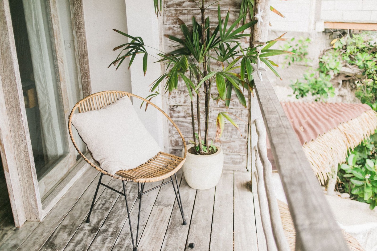 Close-up of a white outdoor seat cushion with piping on a lounge chair frame
