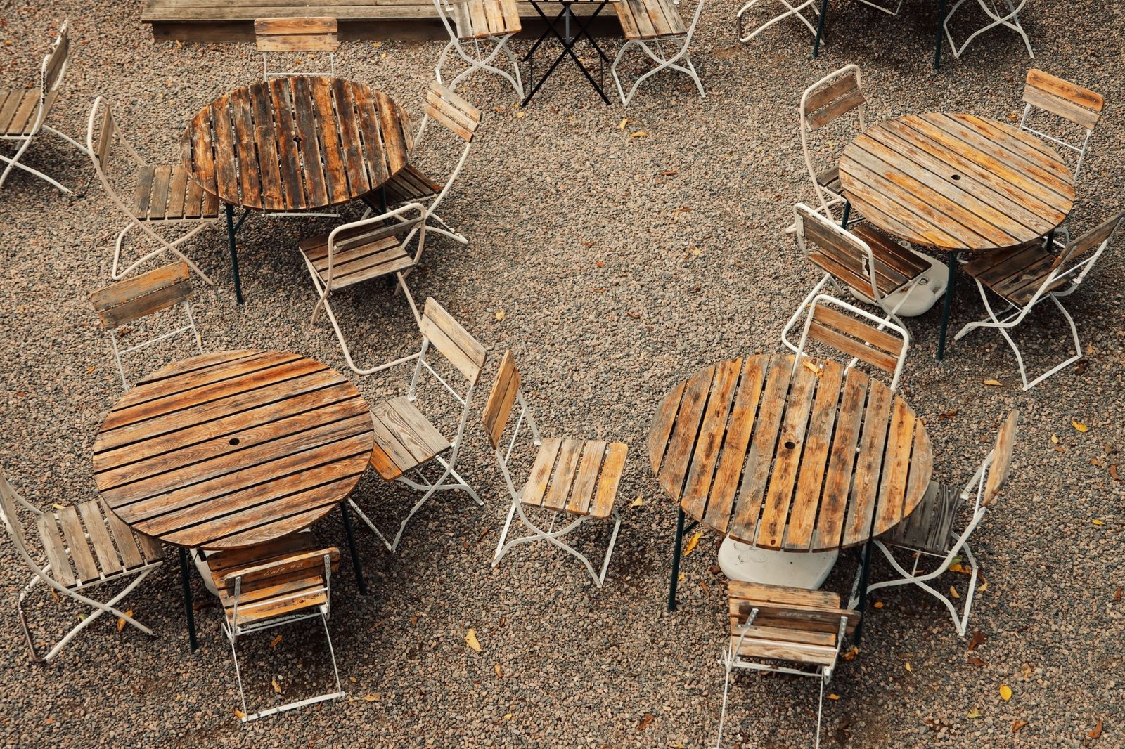 Wooden dining tables and chairs on a restaurant terrace at a hotel project